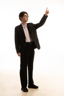 A specific location, a portrait of an Asian man wearing a formal suit raising his hand upwards pointing with his index finger to a specific target, the concept of clicking and interacting with holographic elements, full-body, white background.