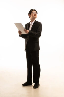 Looking at something, conducting scientific research, reading notes and information, a portrait of an Asian man wearing a formal suit holding a white paper in his hands, following plans and projects, full-body, white background.