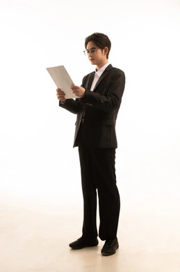 Conducting scientific research, reading notes and information, a portrait of an Asian man wearing a formal suit holding a white paper in his hands, following plans and projects, full-body, white background.