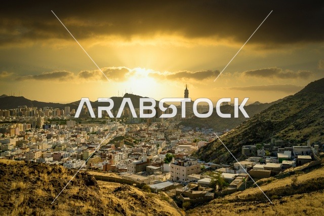 The Royal Clock Tower building in Mecca, the growth and urban development of the towers and skyscrapers surrounding the Holy Mosque, sacred Islamic religious landmarks, and modern architectural engineering art in the Kingdom of Saudi Arabia.