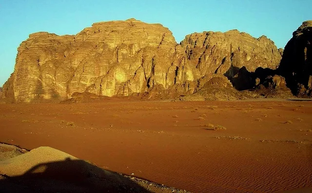 Wadi Al-Disa in the Tabuk region during the day, the land of palm trees and springs, a famous tourist place and area, the natural mountainous terrain in the Kingdom of Saudi Arabia, the growth of wild and thorny plants, the formations and rock structures on the mountainous valleys in historical archaeological sites.