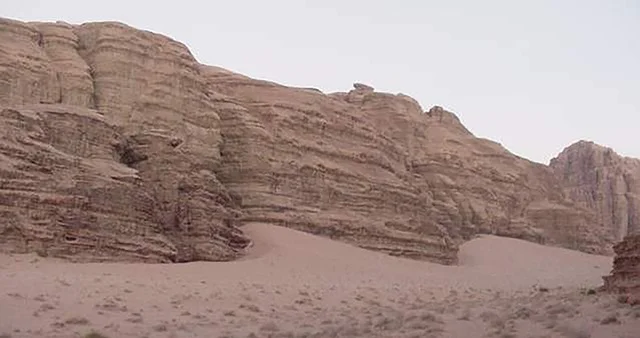 Wadi Al-Disa in the Tabuk region during the day, the land of palm trees and springs, a famous tourist place and area, the natural mountainous terrain in the Kingdom of Saudi Arabia, the growth of wild and thorny plants, the formations and rock structures on the mountainous valleys in historical archaeological sites.