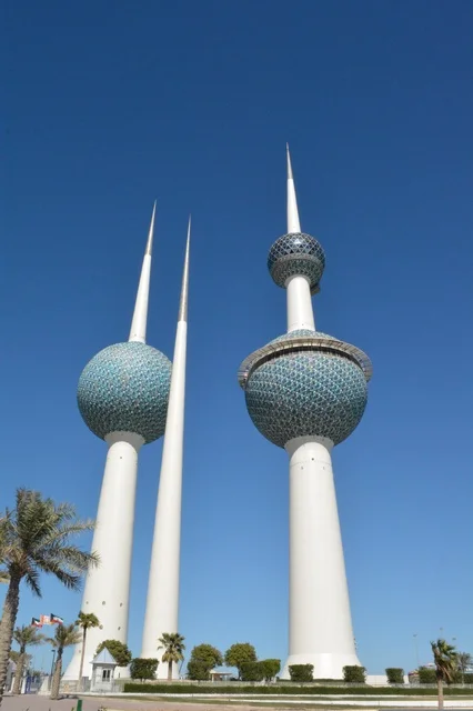 The architectural engineering art of the towers of Kuwait City, skyscrapers and structures on the coast of the Arabian Gulf in the Ras Ajouzah area, the development and urban progress in a modern and advanced style, the green trees and plants, a destination for visitors from all over the world, a famous tourist landmark.