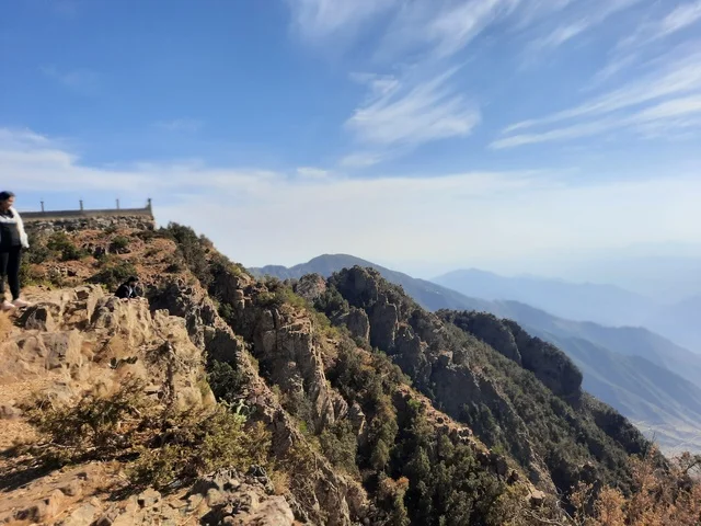 An aerial image of the mountainous environment, plateaus, and highlands, a view of the sky above the landscapes in Al-Soudah Park, the grasses, trees, and green plants in the Soudah Mountains in the Asir region, famous natural tourist spots and areas in the Kingdom of Saudi Arabia.