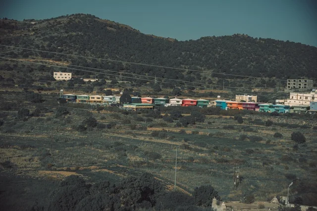 The herbs, trees, and green plants in the Asir region's Al-Soudah mountains, an aerial image of the mountainous environment, plateaus, and highlands, a view of the sky at sunset over the natural landscapes in Al-Soudah Park, famous natural tourist spots and areas in the Kingdom of Saudi Arabia.