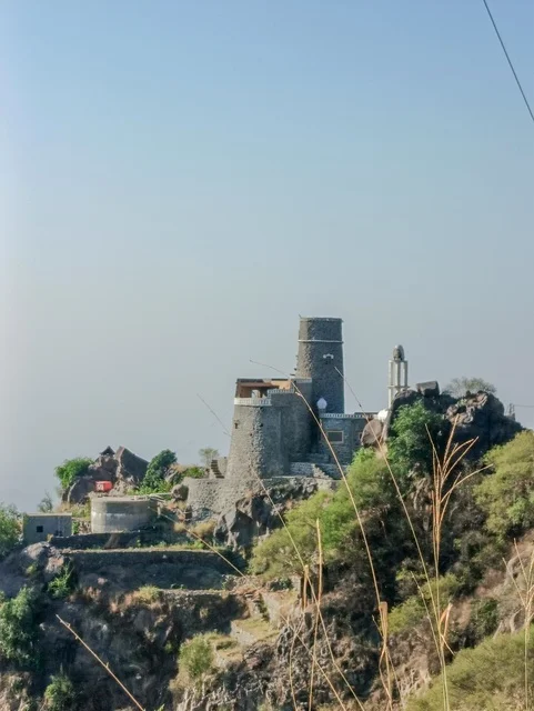 Old houses on the slopes of the Al-Fifa Mountains, green plants and trees, the Al-Fifa Mountains in Jazan, southern Saudi Arabia, famous tourist spots in Saudi Arabia, mountains and highlands, the natural backdrop in Jazan.