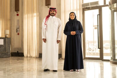 عطلة نهاية الأسبوع، مفهوم الأسرة السعيدة، زوجان عربيان خليجيان سعوديان سائحان يرتديان الزي التقليدي يمشيان ويتجولان في بهو الفندق السياحي، قضاء أجمل الأوقات في أفضل الفنادق الخليجية ، رحلة زوجية ممتعة ، أجواء عائلية مرحة