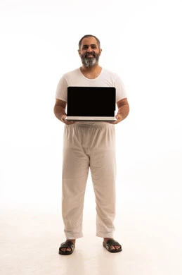 Browse applications and electronic programs via the laptop, use of modern and advanced technological devices, remote business management, a portrait of an Arab Saudi Gulf man wearing white pants and a t-shirt displaying a laptop with a blank black screen, full body, white background.