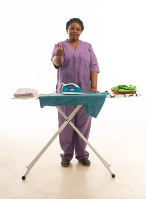 A thumbs-up sign indicating approval; a full-body portrait against a white background of a dark-skinned domestic worker wearing a purple uniform.