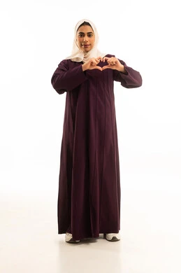 اظهار مشاعر الحب والشغف، مفهوم المحبة والمودة، ايماءات يدين على شكل قلب، بورتريه لامرأه عربيه خليجيه سعوديه محجبة ترتدي العباءة تنظر إلى الكاميرا بتعابير السرور والسعادة، الجسم بالطول الكامل, خلفية بيضاء