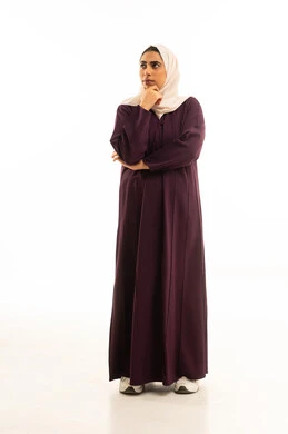 Mind wandering, contemplation, and planning for the future, thinking to find a solution to a problem, a portrait of a Saudi Arabian Gulf woman wearing a hijab and an abaya, looking up with gestures of contemplation and focus, facing problems and challenges in professional life, full-body, white background.