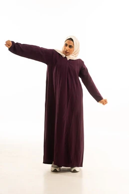 The feeling of tiredness and the need for sleep and rest, the sensation of laziness, lethargy, and exhaustion, a portrait of a Gulf Arab Saudi woman wearing a hijab and an abaya, raising her hand with gestures of yawning and drowsiness, full-body, white background.