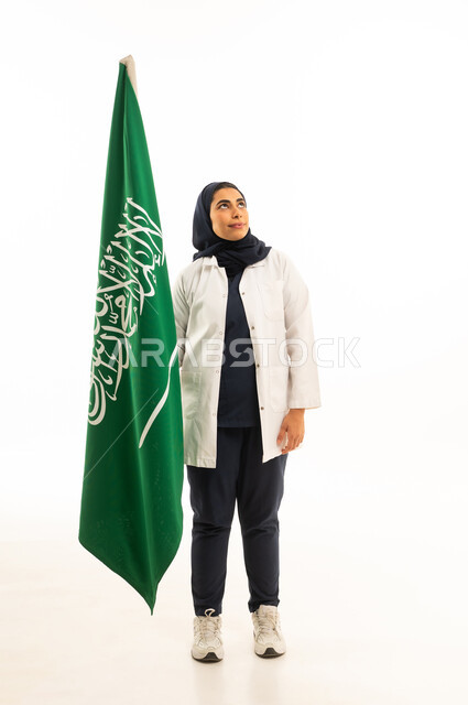 Saudi Flag Day is March 11, National Day is September 23, a portrait of a Saudi Arabian Gulf woman wearing a hijab in casual attire holding the Kingdom's flag, participating in national celebrations, full-body shot, white background.