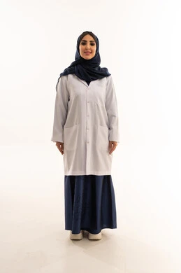 The gestures of happiness are evident on the doctor's face, an Arab Gulf Saudi doctor wearing a white medical coat, smiling in front of the camera, with a white background, full body.