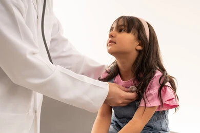 The relationship of trust with the doctors of the Saudi Red Crescent Authority, a Gulf Arab Saudi girl wearing casual attire sits on the examination bed looking at her doctor with confidence, an Arab Gulf Saudi doctor wearing a white lab coat practicing his daily work, close-up portrait, white background.