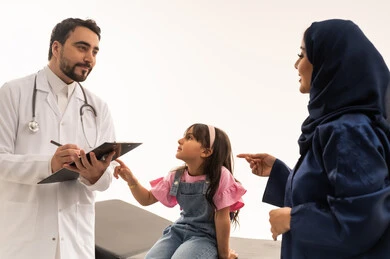 Regular follow-up in rotation between doctors to check on patients, a Saudi Gulf Arab doctor wearing traditional attire with a white medical coat talking to the resident doctor with the child to follow up on the latest updates, a veiled Saudi Gulf Arab female doctor wearing a blue abaya following up with the doctor on new health developments, a small girl wearing casual attire sitting on the examination bed, close-up portrait, white background.