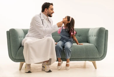 The necessary periodic examination to protect the teeth, an Arab Saudi Gulf doctor wearing a white medical coat while examining the gums and mouth, an Arab Gulf Saudi girl wearing casual attire sitting on the clinic's sofa, full-body portrait, white background.