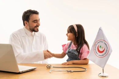 The warm and trusting relationship between doctor and patient; a close-up portrait of a Saudi Arabian doctor wearing a white medical coat over his traditional Saudi thobe; a young Saudi Arabian girl in casual clothes shaking hands with the friendly doctor after the examination; white background.