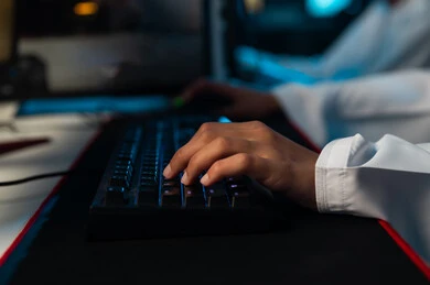 Clicking on the desktop computer keyboard, multiple uses of technical devices in communication and electronic games, spending special times with friends, close-up image.