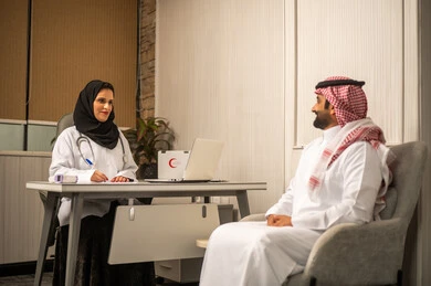 Reviewing and recording medical data, an Arab Gulf Saudi female doctor wearing a medical coat and stethoscope is providing medical care to the patient, offering consultations and health services, the concept of medicine and healthcare.