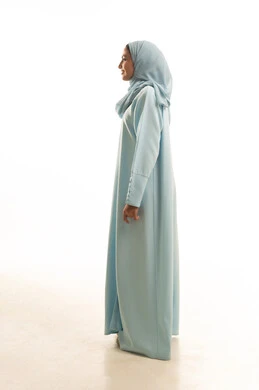 1766034800VaAttention to elegance and outward appearance, the concept of femininity and self-confidence, standing upright and poised, a profile portrait of a smiling, veiled young Arab woman from the Gulf region of Saudi Arabia, wearing an abaya and looking with gestures of happiness and joy, taking a personal photograph for official documents, full body length, white background22fZUFHI