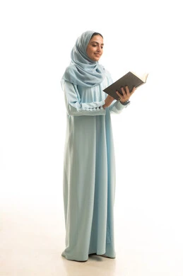 قضاء الوقت بالقراءة والتعلم والثقافة، مفهوم التعلم الذاتي، ايماءات التمعن والتركيز، بورتريه لامراة عربيه خليجيه سعودية ترتدي العباءة و الحجاب تقوم بمطالعة كتاب، الجسم بالطول الكامل، خلفية بيضاء