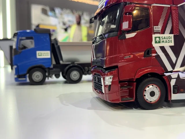Models of Saudi manufacturing trucks at the "Made in Saudi Arabia 2025" exhibition, a prominent industrial event aimed at enhancing Saudi national services, showcasing the quality and diversity of national industries and their innovations. The exhibition carries the slogan "We Empower Manufacturing," organized by the Saudi Export Development Authority, 2025 at the Riyadh Exhibition Center.