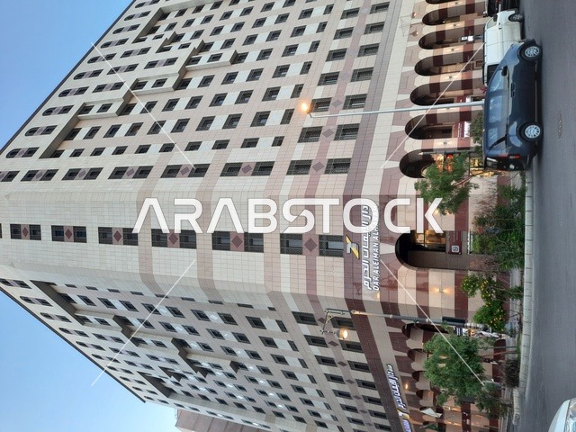 The architectural art of the buildings, towers, and hotels surrounding the Prophet's Mosque, the traffic of cars in Medina, a destination for Muslims from around the world, the view of the roads and streets during the day, famous landmarks and tourist attractions.