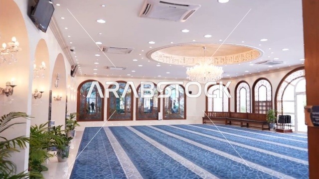 A religious Islamic mosque in the Kingdom of Saudi Arabia, a place for worship and getting closer to Allah Almighty, the Omar Ibn Al-Jamouh Mosque in Ibn Khaldun neighborhood (Al-Muraykabat) in the city of Dammam, a small indoor bird garden, attention to planting green plants in the mosque, interior decoration in the Islamic style.