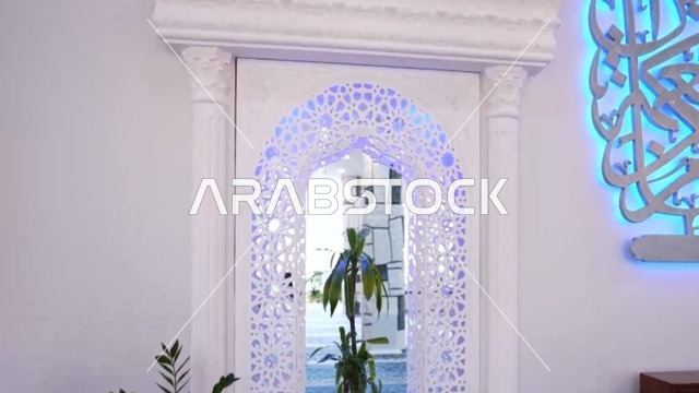 A religious Islamic mosque in the Kingdom of Saudi Arabia, a place for worship and getting closer to Allah Almighty, the Omar Ibn Al-Jamouh Mosque in Ibn Khaldun neighborhood (Al-Muraykabat) in the city of Dammam, a small indoor bird garden, attention to planting green plants in the mosque, interior decoration in the Islamic style.