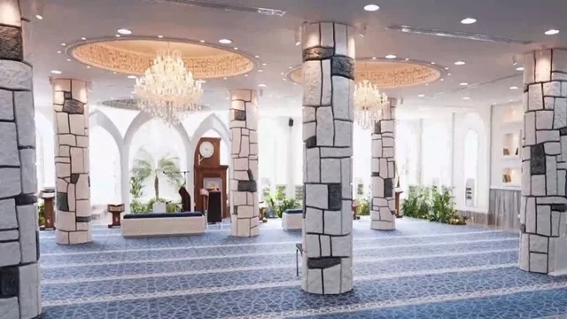 The Omar bin Al-Jamouh Mosque in Ibn Khaldun neighborhood (Al-Muraykabat) in the city of Dammam is a religious Islamic mosque in the Kingdom of Saudi Arabia, featuring a small indoor bird garden, chandeliers and hanging lights on the ceiling, green plants inside the mosque, and interior decoration in the Islamic style.