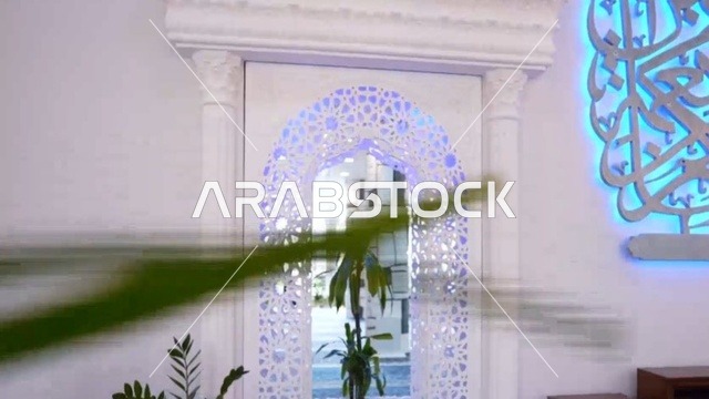 A religious Islamic mosque in the Kingdom of Saudi Arabia, a place for worship and getting closer to Allah Almighty, the Omar Ibn Al-Jamouh Mosque in Ibn Khaldun neighborhood (Al-Muraykabat) in the city of Dammam, a small indoor bird garden, attention to planting green plants in the mosque, interior decoration in the Islamic style.