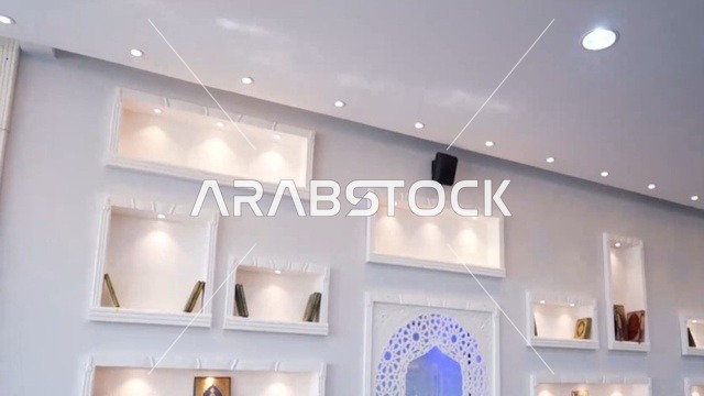 A religious Islamic mosque in the Kingdom of Saudi Arabia, a place for worship and getting closer to Allah Almighty, the Omar Ibn Al-Jamouh Mosque in Ibn Khaldun neighborhood (Al-Muraykabat) in the city of Dammam, a small indoor bird garden, attention to planting green plants in the mosque, interior decoration in the Islamic style.