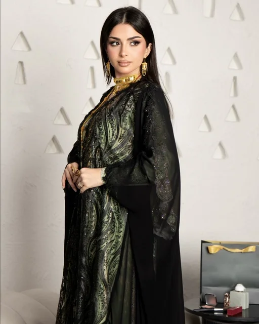 Modern women's fashion, the concept of beauty, elegance, and attention to appearance, a Gulf Arab Saudi woman wearing a black embroidered abaya made of chiffon and lace in a modern style. Modern women's fashion, the concept of beauty, elegance, and attention to appearance, a Gulf Arab Saudi woman wearing a black embroidered abaya made of chiffon and lace in a modern style.