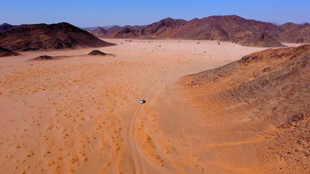 Ancient historical archaeological sites, rock formations and structures in the middle of the Saudi desert during the day, tourist attractions in the desert areas of the Kingdom, dry herbs in the desert regions.