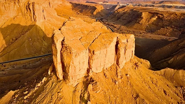 Ancient historical archaeological sites, rock formations and structures in the middle of the Saudi desert during the day, tourist attractions in the desert areas of the Kingdom, dry herbs in the desert regions.