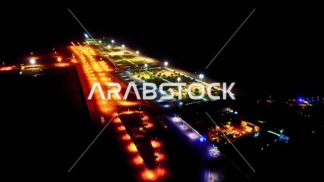 Architectural engineering artworks amidst the marine nature, famous coastal tourist spots in the Kingdom of Saudi Arabia, an aerial view of a lit seaside corniche at night in the Kingdom of Saudi Arabia, areas for recreational marine trips and tours, attracting and drawing tourists from all over the world.