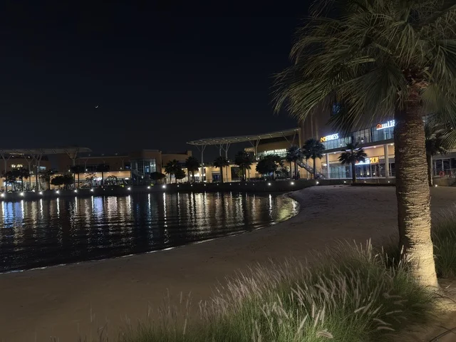 A promenade in The Move complex in Jubail Industrial City in the Eastern Province, a complete shopping and entertainment experience, a modern entertainment destination for the Jubail Corniche, cafes and restaurants for families and youth, a vibrant atmosphere for the year 2025.