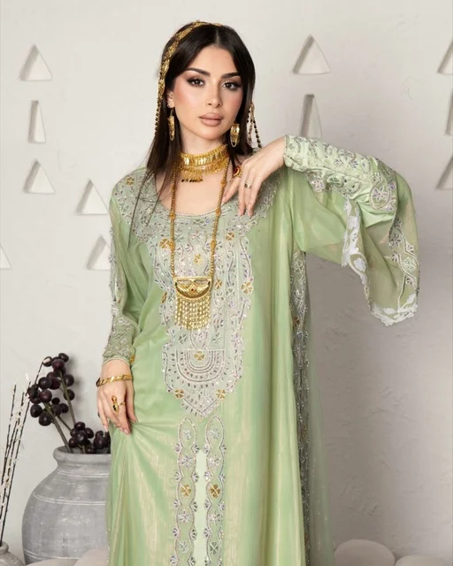 Adorning oneself with jewelry and gold ornaments, wearing a modern women's outfit, an Arab Gulf Saudi woman wearing an embroidered abaya, beauty, elegance, and attention to external appearance. Adorning oneself with jewelry and gold ornaments, wearing a modern women's outfit, an Arab Gulf Saudi woman wearing an embroidered abaya, beauty, elegance, and attention to external appearance.