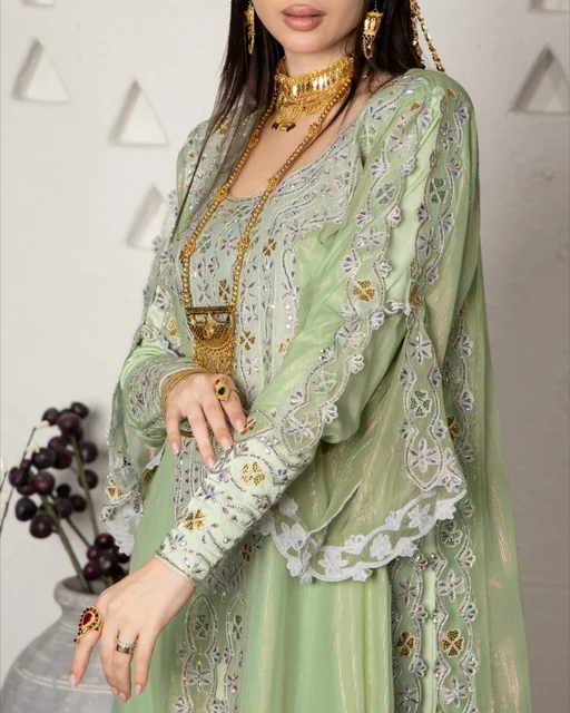Adorning oneself with jewelry and gold ornaments, wearing a modern women's outfit, an Arab Gulf Saudi woman wearing an embroidered abaya, beauty, elegance, and attention to external appearance. Adorning oneself with jewelry and gold ornaments, wearing a modern women's outfit, an Arab Gulf Saudi woman wearing an embroidered abaya, beauty, elegance, and attention to external appearance.