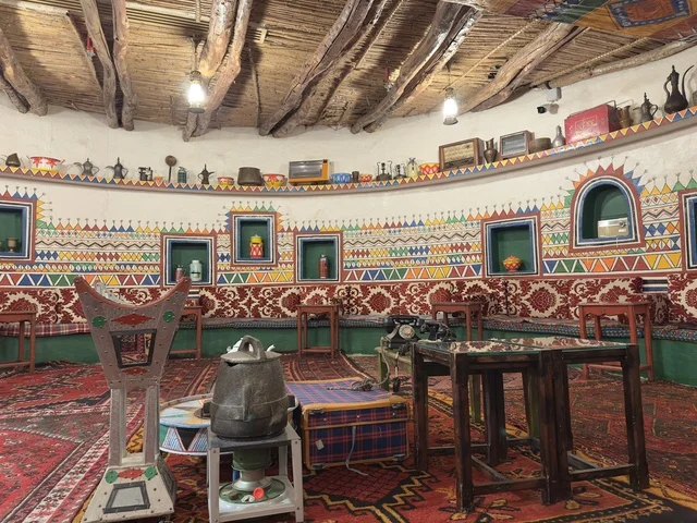 Details of the Arabic seating in red, the restaurant hall inside the heritage village is a prominent museum and restaurant located on the Corniche of Dammam in the Kingdom of Saudi Arabia, a restaurant that offers traditional Saudi cuisine.