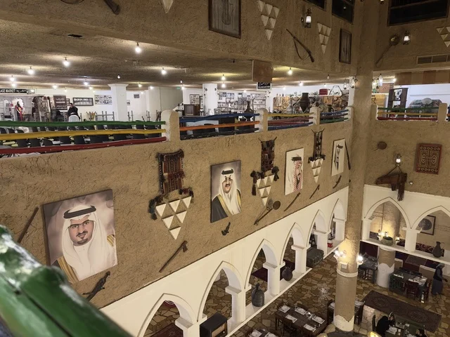 جدران طينية تحمل أعمال فنية وصور لمؤسسي الدولة، الحفاظ على التراث المحلي وعرضه للزوار، القرية الشعبية التراثية متحف ومطعم بارز يقع على كورنيش الدمام في المملكة العربية السعودية،  بيئة ريفية أو تاريخية.