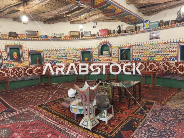 A seat upholstered with striped heritage fabrics, preserving local heritage and showcasing it to visitors, the Heritage Village is a prominent museum and restaurant located on the Corniche of Dammam in the Kingdom of Saudi Arabia, offering a rural or historical environment.