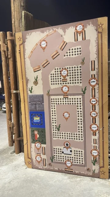 A signboard in South West (Cowboy) town in Al Zahra neighborhood on King Abdulaziz Road in Jeddah for the year 2025, a recreational tourist destination, various outdoor activities, a place to have a good time in the Kingdom of Saudi Arabia, buildings in the classic Western style.