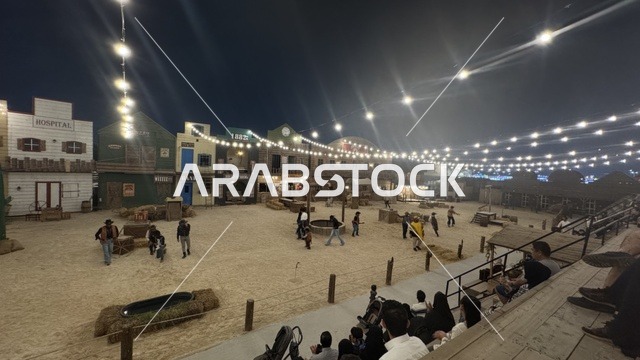 Southwest Town (Cowboy) in Al-Zahra neighborhood on Al-Aziz Road in Jeddah in 2025, buildings in classic Western style, various outdoor activities, a recreational tourist destination, a place for King Abdul to spend enjoyable time in the Kingdom of Saudi Arabia, wearing American cowboy attire.