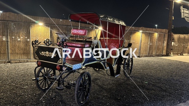 A traditional horse-drawn carriage in the South West (Cowboy) town in the Al-Zahra neighborhood on King Abdulaziz Road in Jeddah in 2025, buildings in the classic Western style, a recreational tourist destination, a place to have a good time in the Kingdom of Saudi Arabia, wearing American cowboy attire.
