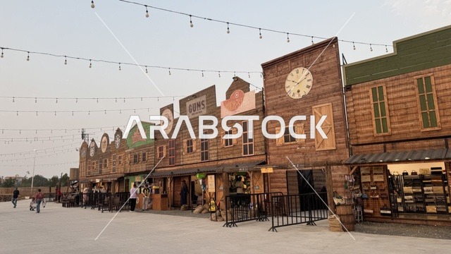 Southwest Town (Cowboy) in Al-Zahra neighborhood on King Abdulaziz Road in Jeddah in 2025, wearing American cowboy attire, a place to have a good time in the Kingdom of Saudi Arabia, buildings in classic Western style.