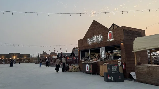 A place to have a good time in the Kingdom of Saudi Arabia, buildings in the classic Western style, the Darat Al-Qahwa store in the South West (Cowboy) town in the Al-Zahra neighborhood on King Abdulaziz Road in Jeddah in 2025, wearing American cowboy attire.