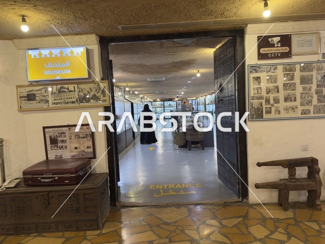 Entrance to a museum or exhibition place with a sign that says "ENTRANCE" on the ground. The village is designed to reflect the traditional architecture of the area. The heritage folk village is a prominent museum and restaurant located on the Corniche of Dammam in the Kingdom of Saudi Arabia.