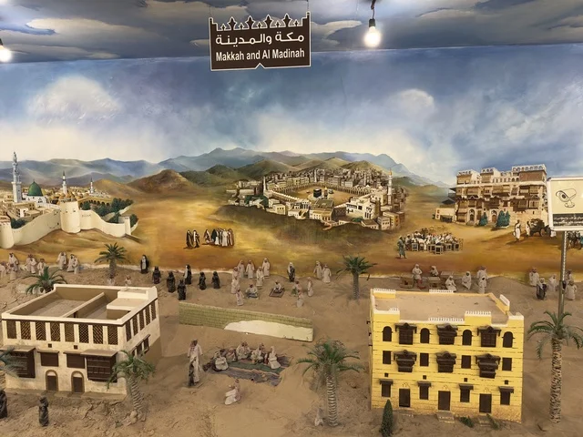 A colored image of Mecca and Medina in the past at the Heritage Village on the Corniche of Dammam, a cultural and tourist landmark that combines heritage, restaurants, and cafes, a place to spend enjoyable time with family in the Kingdom of Saudi Arabia.